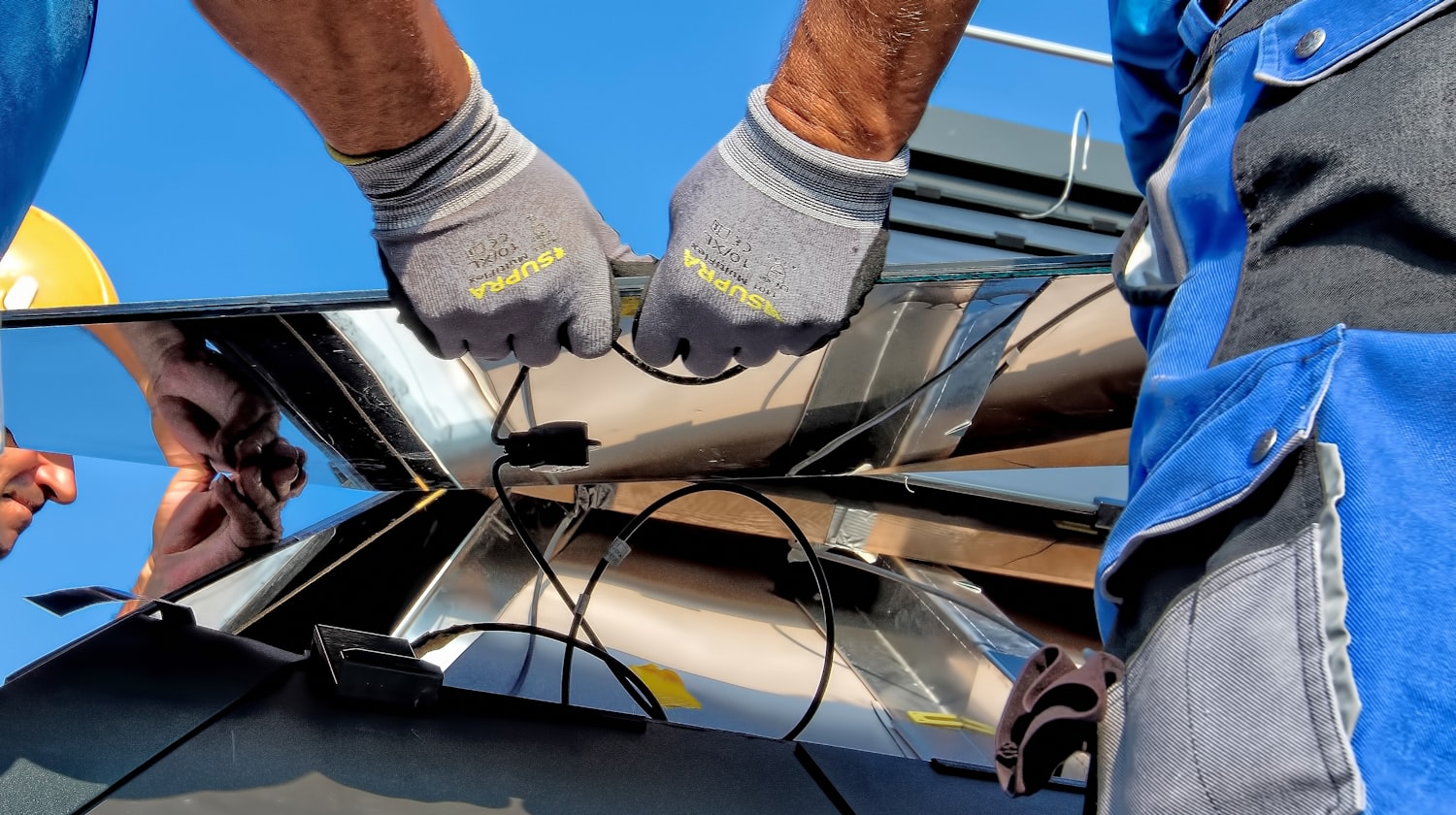 Technicians carefully installing rooftop solar panels — Lotus Sun Energy quality workmanship