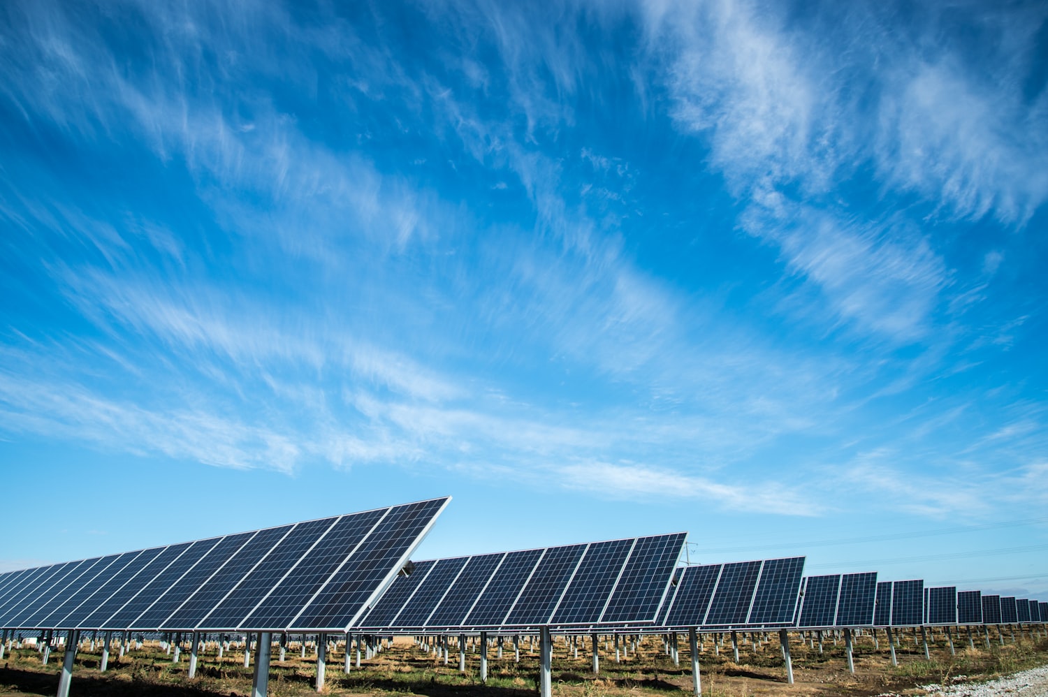 Solar panels under a wide blue sky